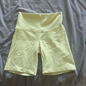 Aritzia (TriAction) yellow biker shorts. NEVER WORN